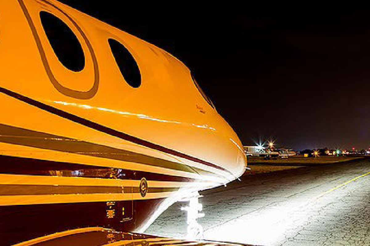 Beechcraft Premier Jet Series Landing Lights At Night on Runway
